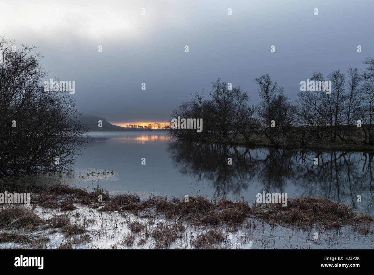 Sunrise over Malham Tarn on a very still and calm winters morning in the Yorkshire Dales, England, UK Stock Photo
