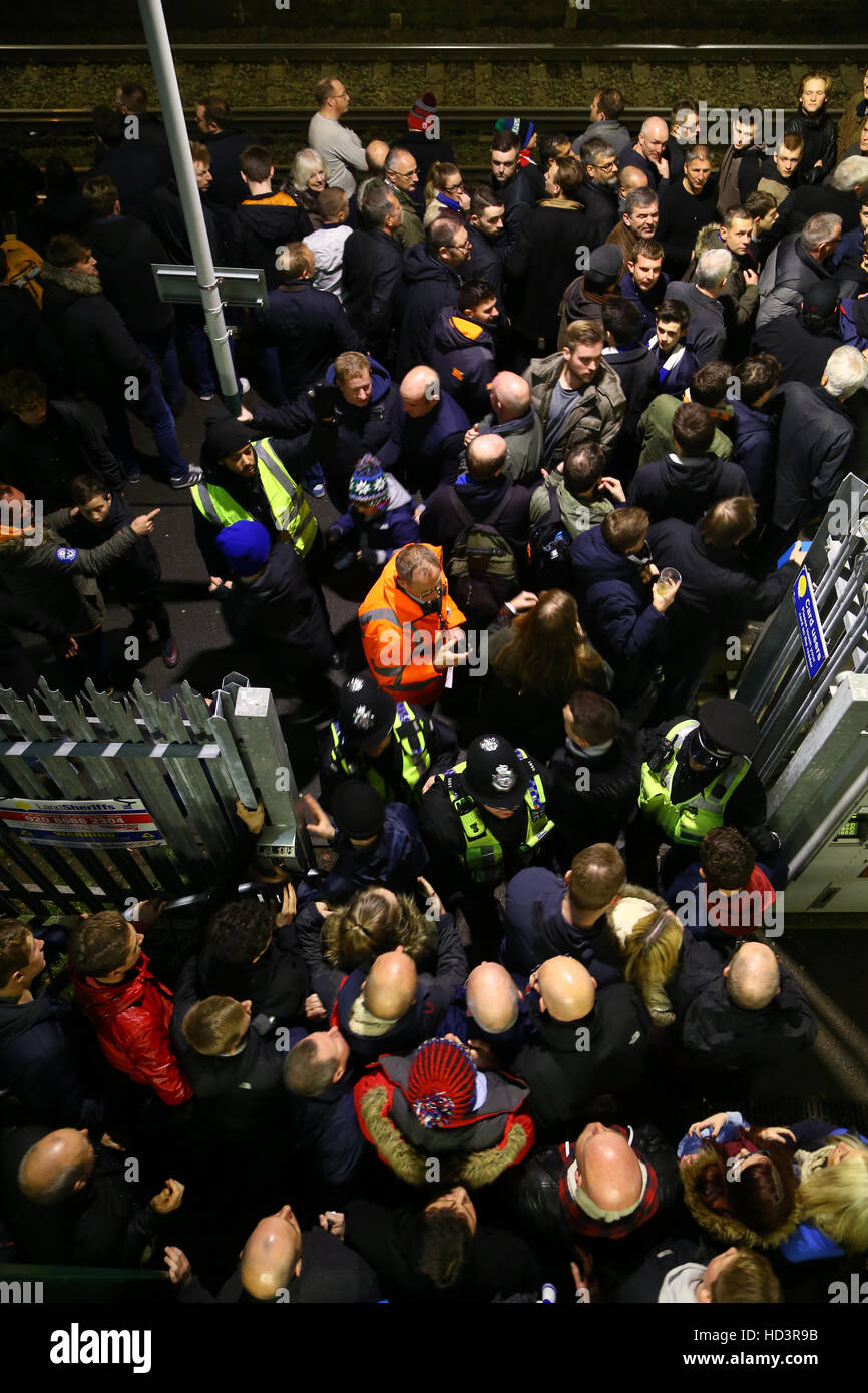 Police officers hold back football supporters who are wait trying to enter Falmer railway station for a Southern train after the Brighton and Hove Albion v Leeds United Sky Bet Championship match at the AMEX Stadium, Brighton. Stock Photo