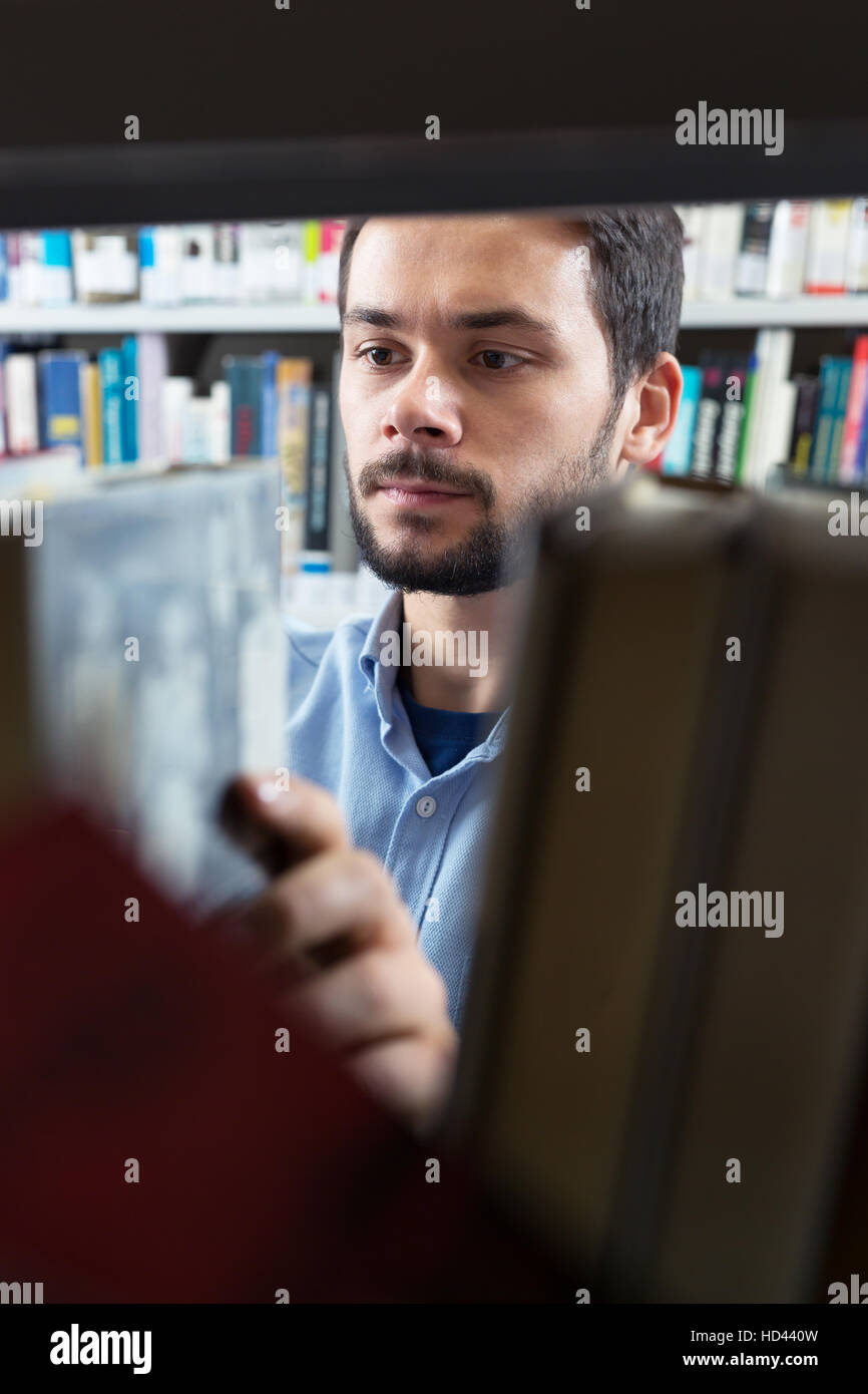 Male College Student Taking Book From Shelf In Library Stock Photo Alamy male-college-student-taking-book-from-shelf-in-library-stock-photo-alamy