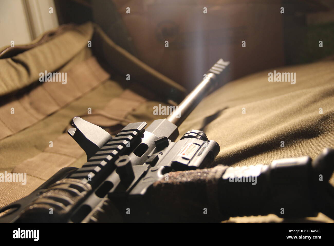 Closeup shot of a customized AR15 assault rifle laying on a brown padded rifle case Stock Photo