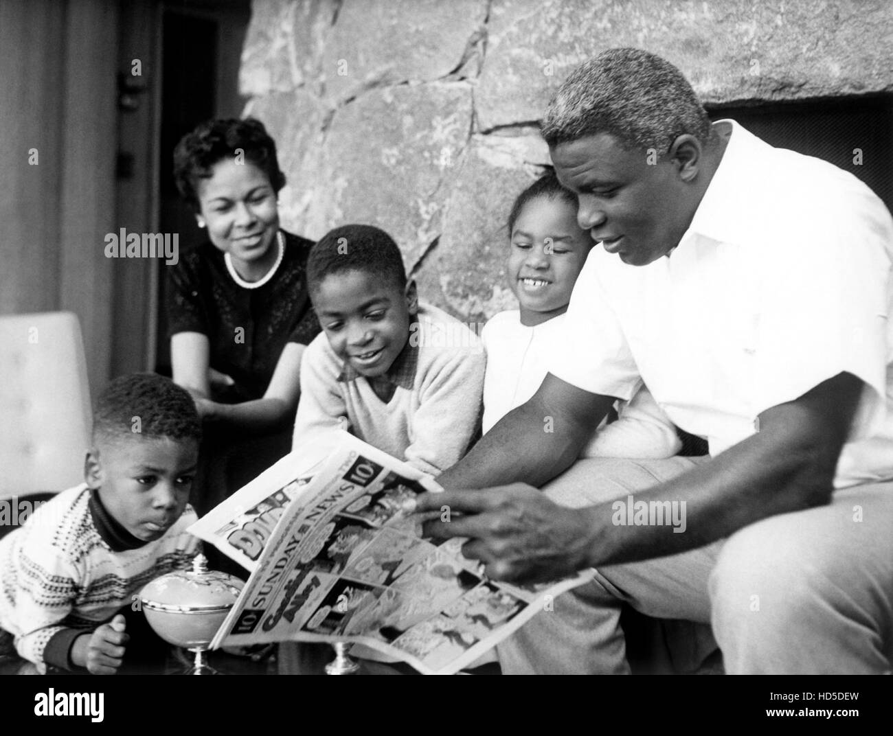 PERSON TO PERSON, baseball star Jackie Robinson (right) with his family from left: David Robinson, Rachel Robinson (rear), Stock Photo