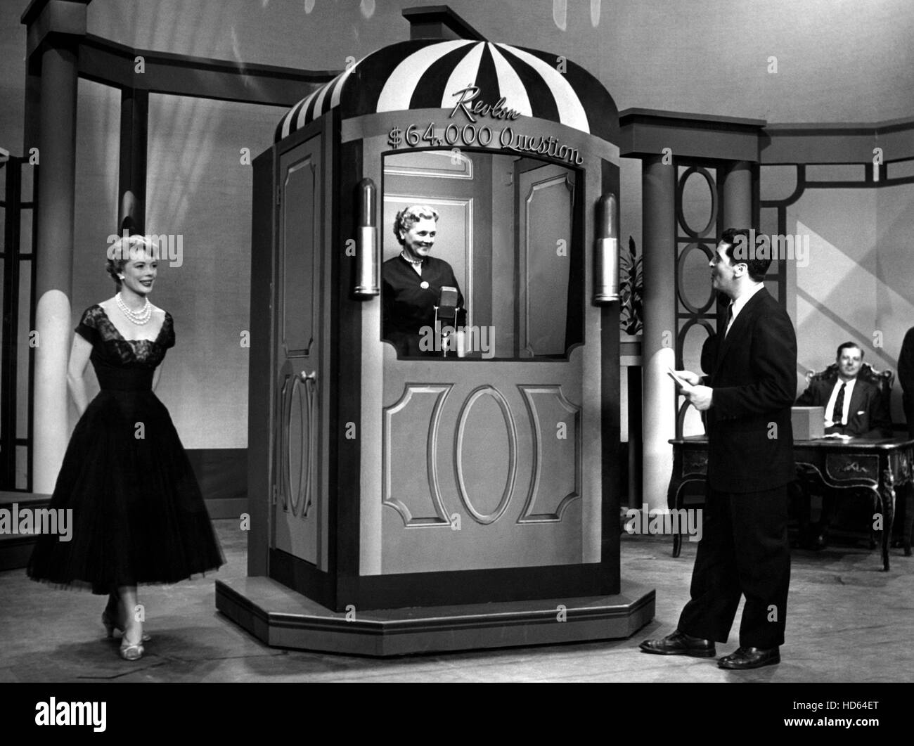 THE $64,000 QUESTION, Hal March, pops the $8000 question to a contestant,  who is in an isolation booth, 6/10/55 Stock Photo - Alamy