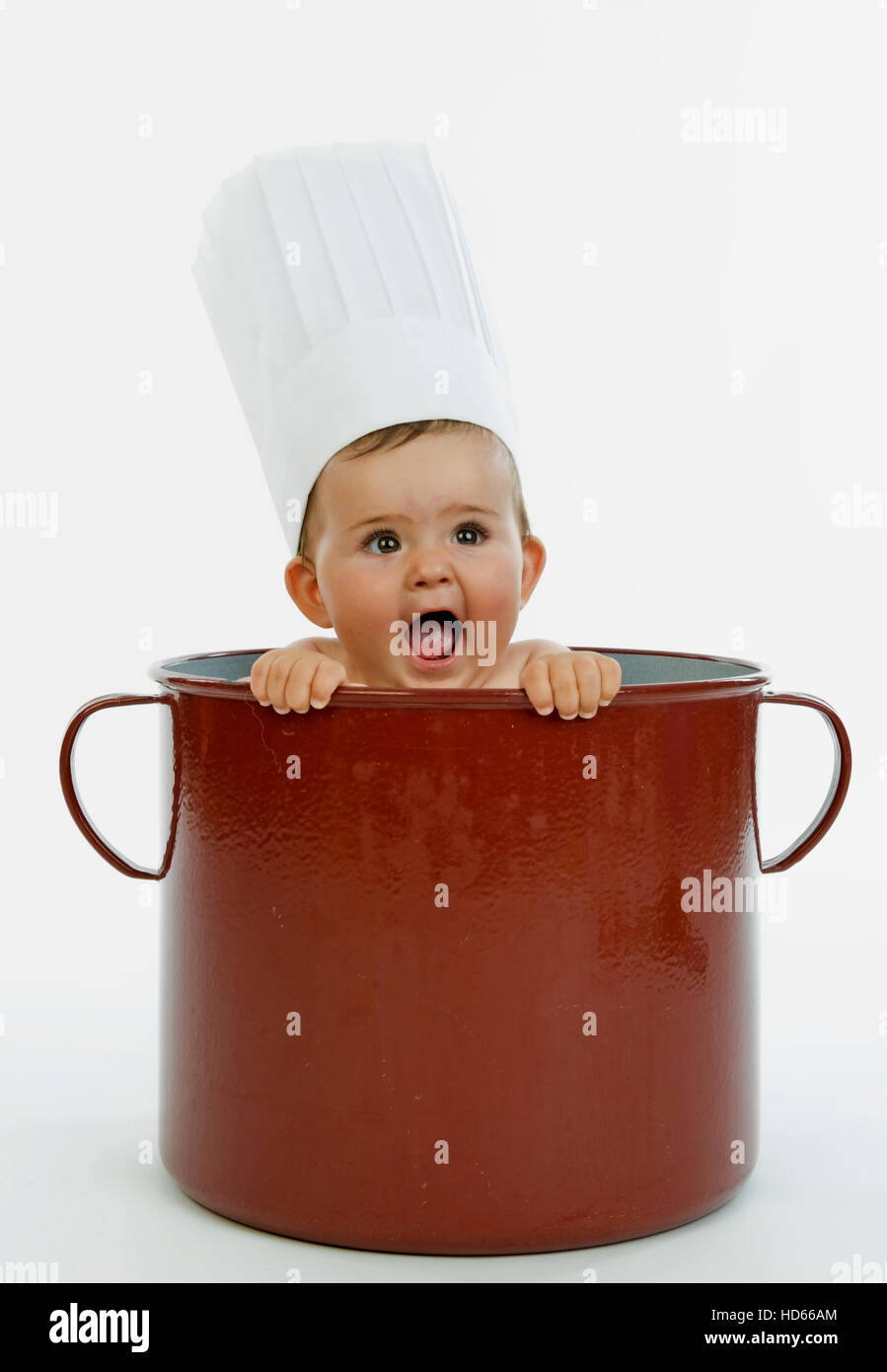 Infant wearing a chef's cap in a pot Stock Photo