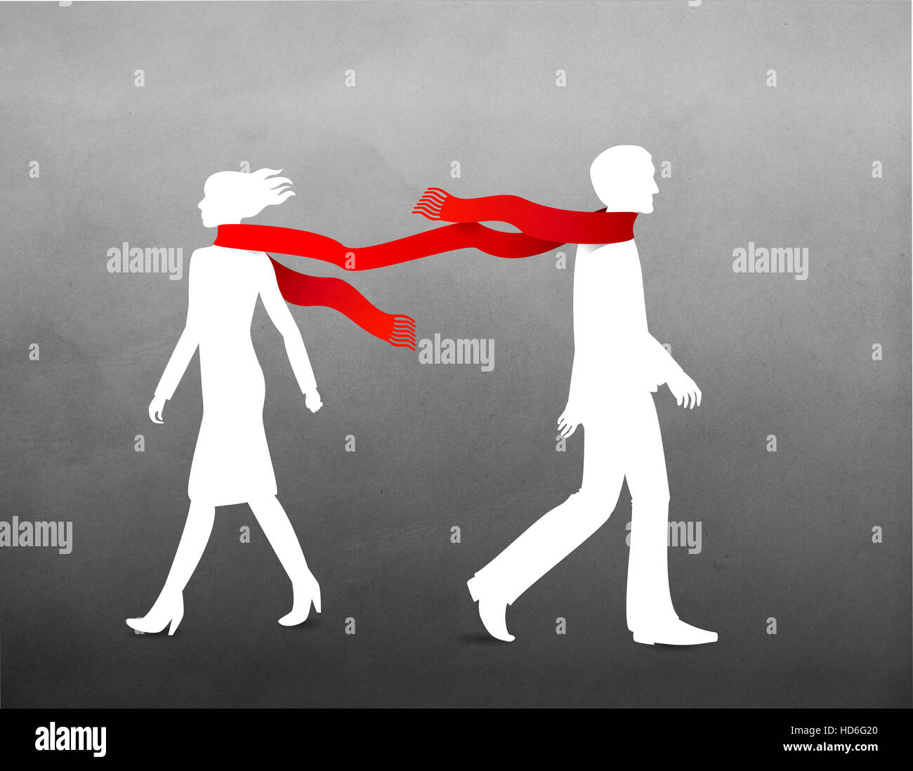 Man and women in scarf walking on windy day Stock Photo