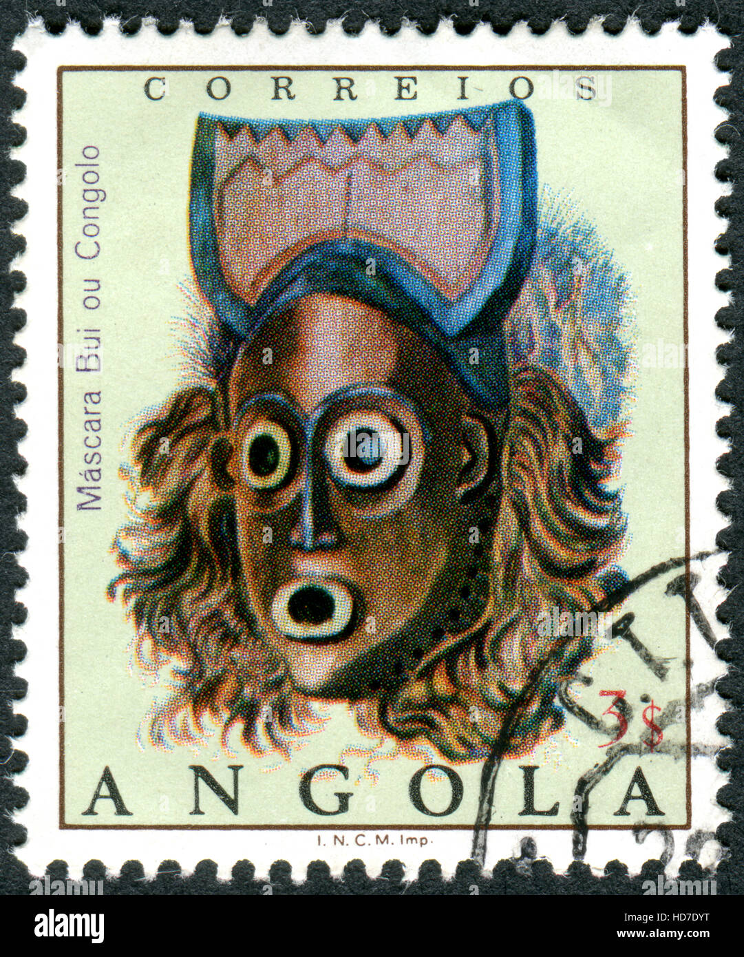 ANGOLA - CIRCA 1976: A stamp printed in Angola shows the Bui ou Congolo mask, circa 1976 Stock Photo