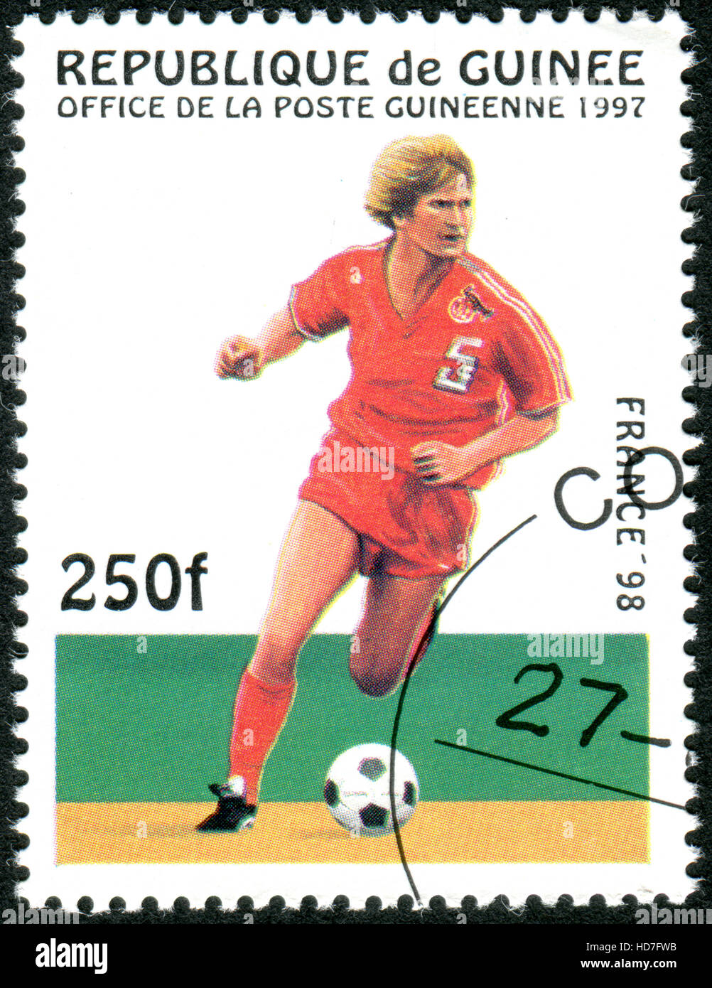 GUINEA - CIRCA 1997: A stamp printed in Guinea dedicated to the FIFA World Cup 1998 - France, shows the Game scene, circa 1997 Stock Photo