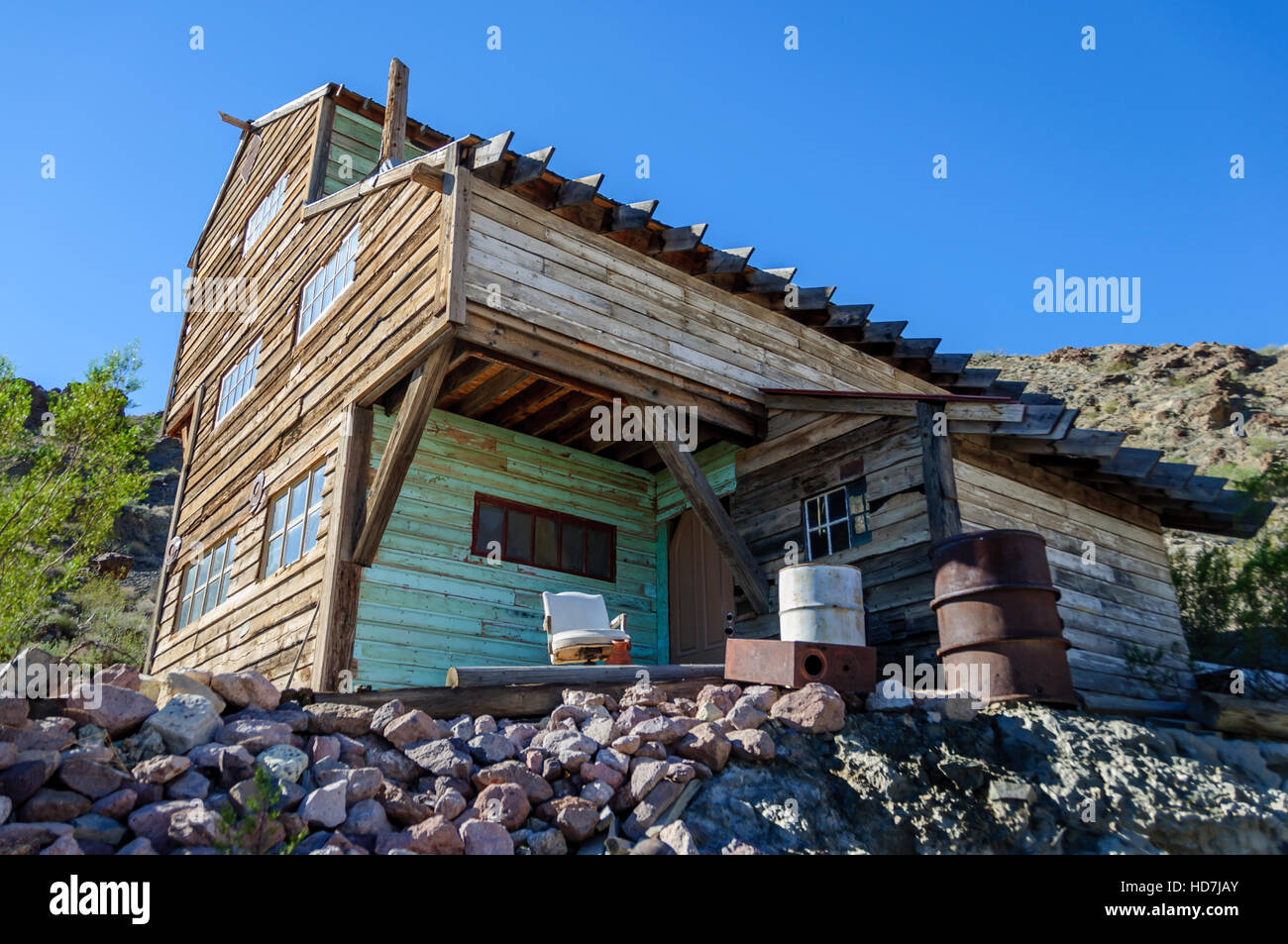 Disturbing angle of abandoned building at Techatticup Mine, a gold + silver mine and ghost town used as a movie set in Nevada. Stock Photo