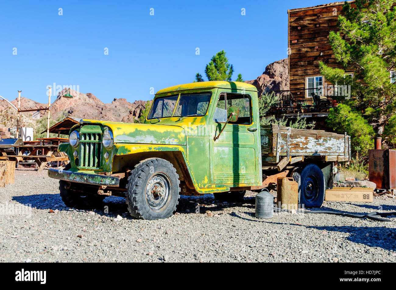 Old pickup truck with wooden truck bed and faded peelpaint in desert sun at Techatticup Mine near Route 66 often used as a filming location in Nevada. Stock Photo
