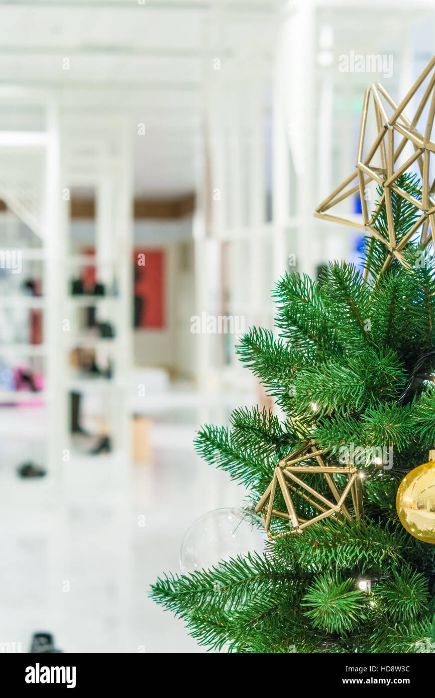 Christmas tree with gold decoration in shopping mall.Christmas clearance sales at the shopping mall. Stock Photo