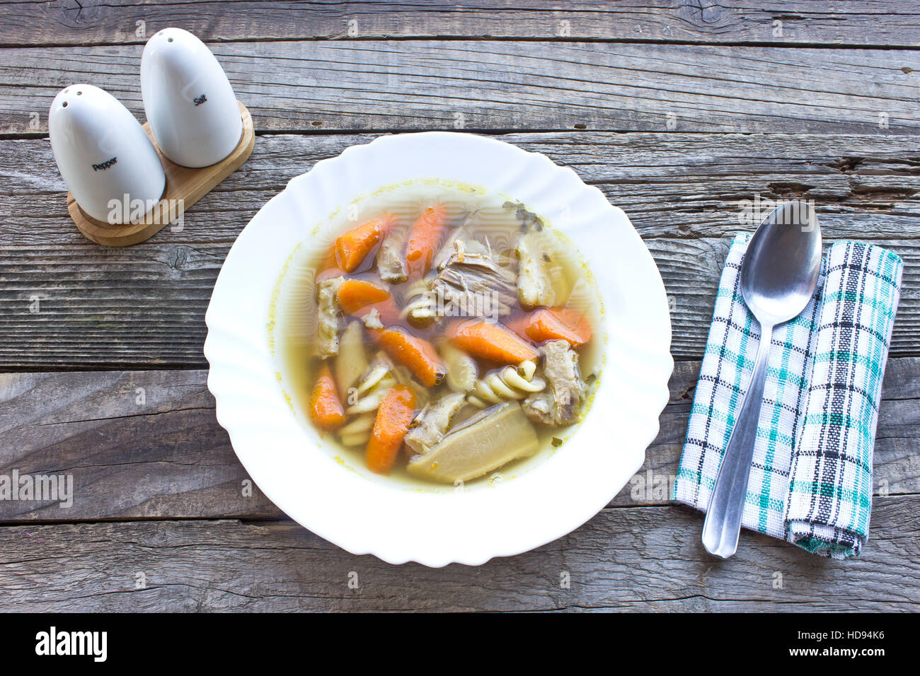 Beef and vegetable broth soup on wooden table Stock Photo