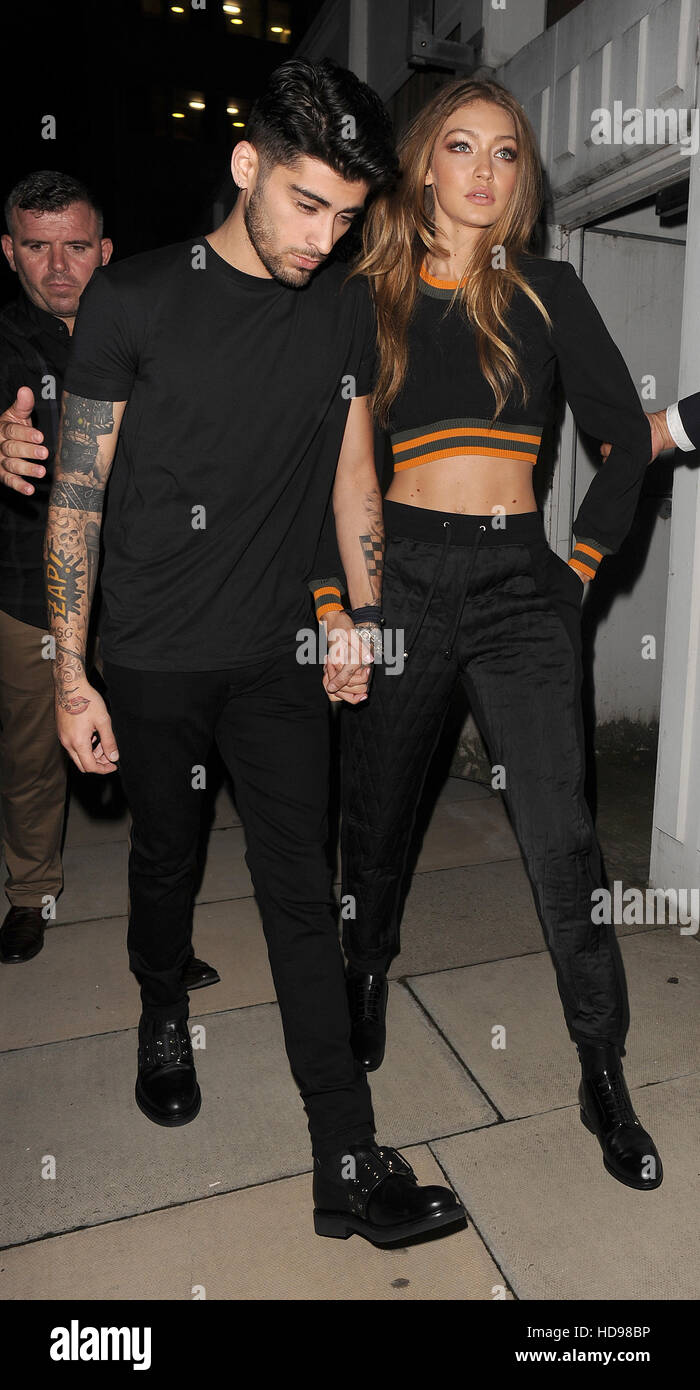 Zayn Malik and Gigi Hadid leaving the Versace Versus show Featuring