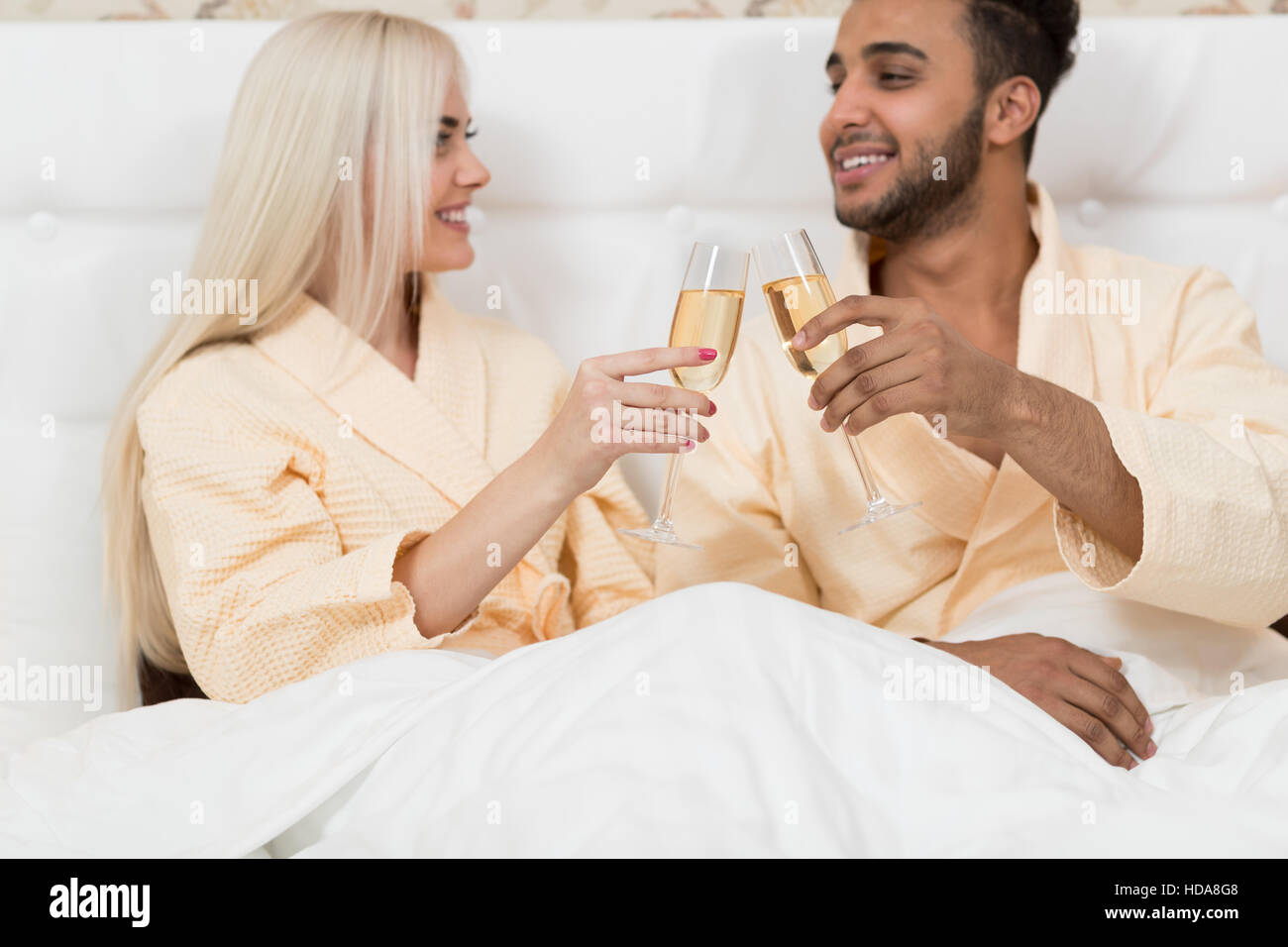 Young Couple Hold Glass Of Champagne Sitting Bed, Happy Smile Man And ...