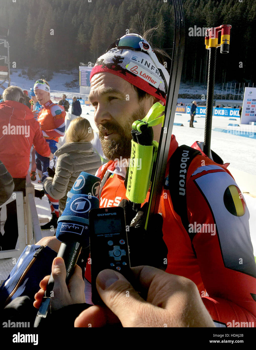 The German biathlete Michael Roesch, who competes for Belgium, talks to ...
