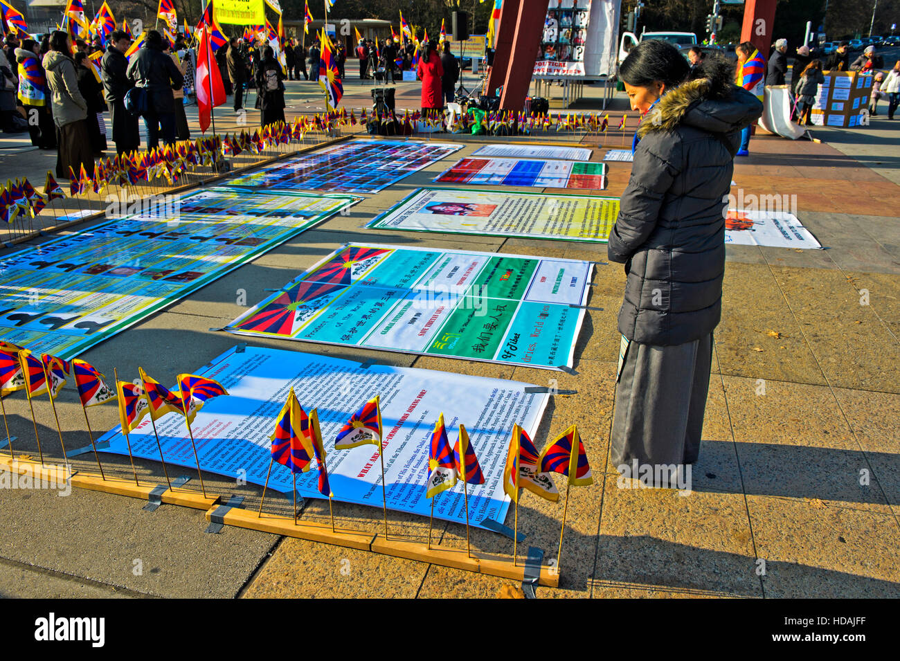 Geneva, Switzerland. 10 December 2016. Tibetan woman looking at posters on Place des Nations in Geneva, Switzerland, during a protest rally against human rights violations in Tibet organised by the Tibetan Community in Switzerland and Liechtenstein on the occasion of the Human Rights Day and in commemoration of the 27th anniversary of the conferment of the Nobel Peace Prize to the Dalai Lama and held on 10 December 2016 in Geneva, Switzerland Stock Photo