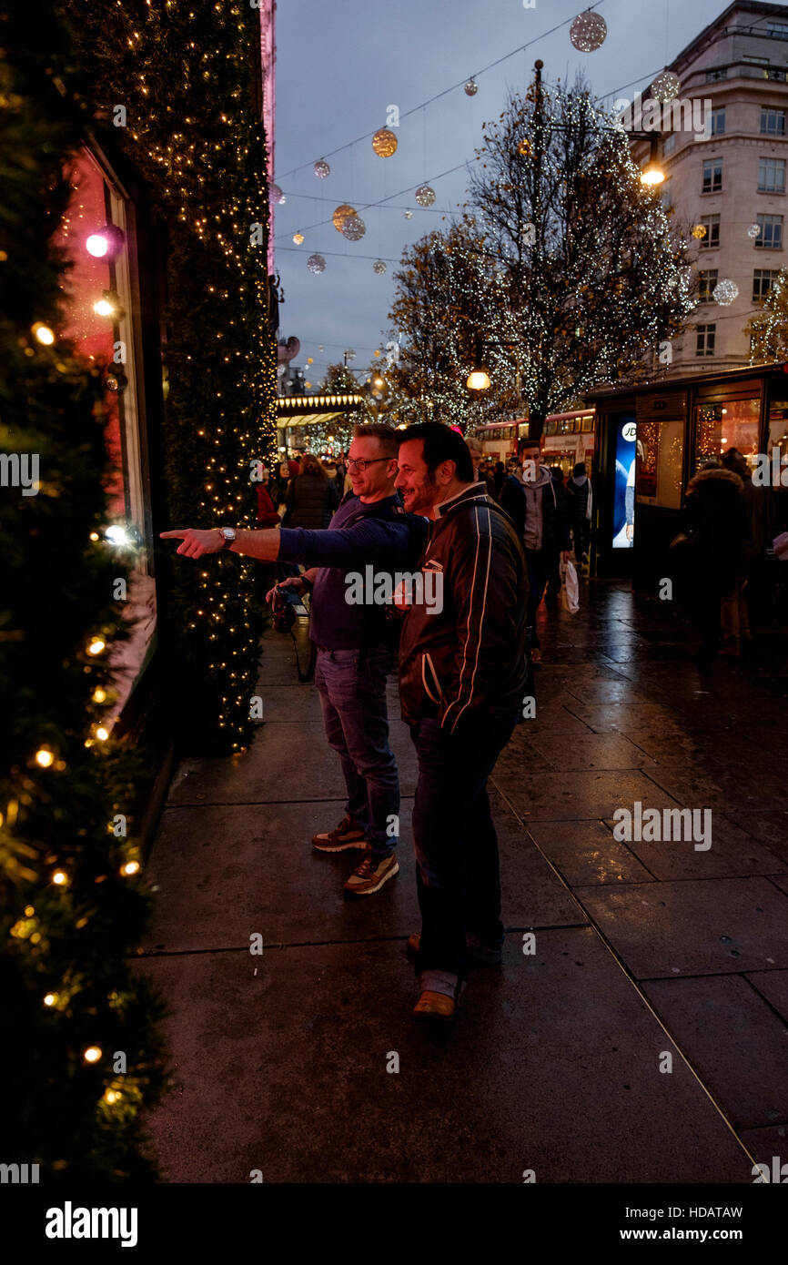 London, UK. 10th Dec, 2016. Christmas Shopping in Londons West End on 10/12/2016 at Oxford Street , . Shoppers stop to admire the Selfridges window displays. Credit:  Julie Edwards/Alamy Live News Stock Photo