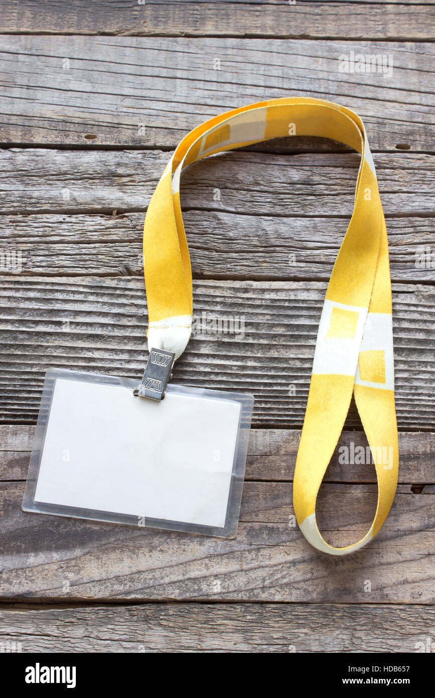 Blank ID card tag isolated on wooden background Stock Photo