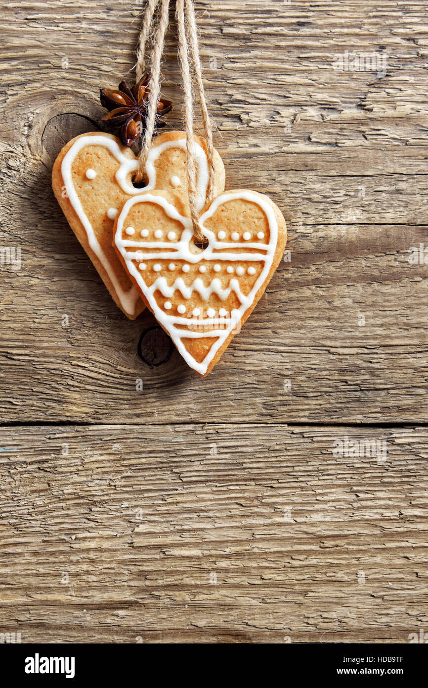 Christmas wooden background with gingerbread cookies heart shape, copy ...