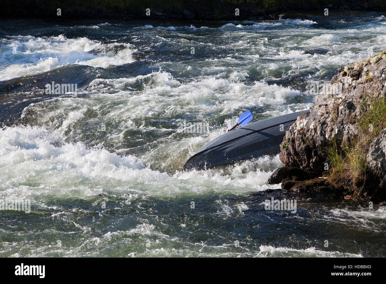 Kayaker turning over in the cataract whitewater Stock Photo