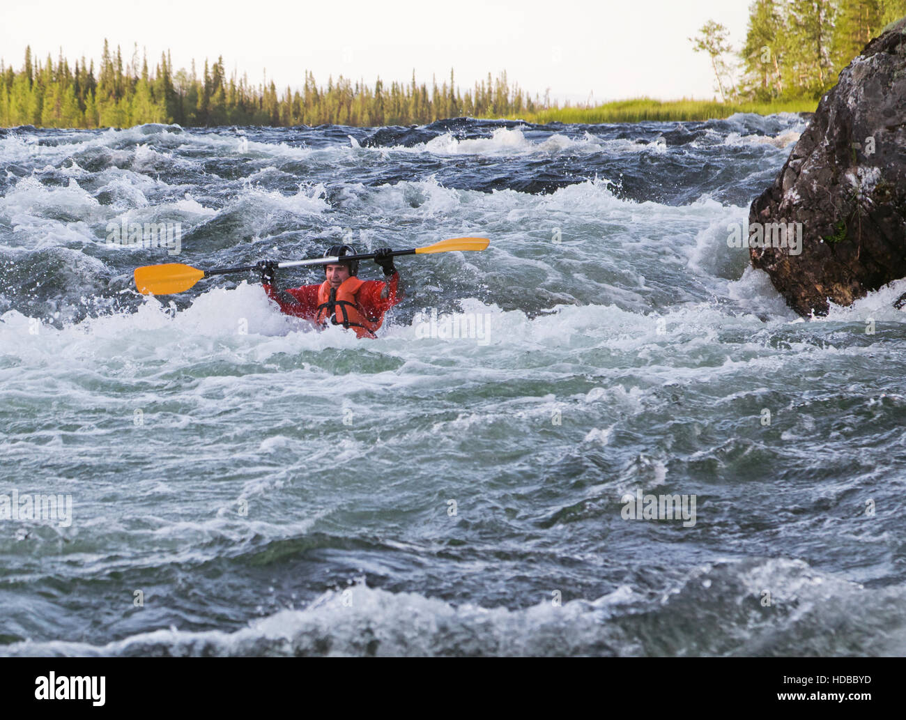 Kayaker turning over in the cataract whitewater Stock Photo