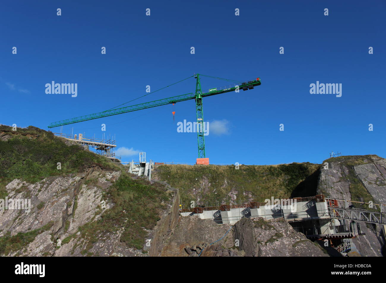 Crane building RNLI new lifeboat station clifftop cliffs Pembrokeshire UK Stock Photo