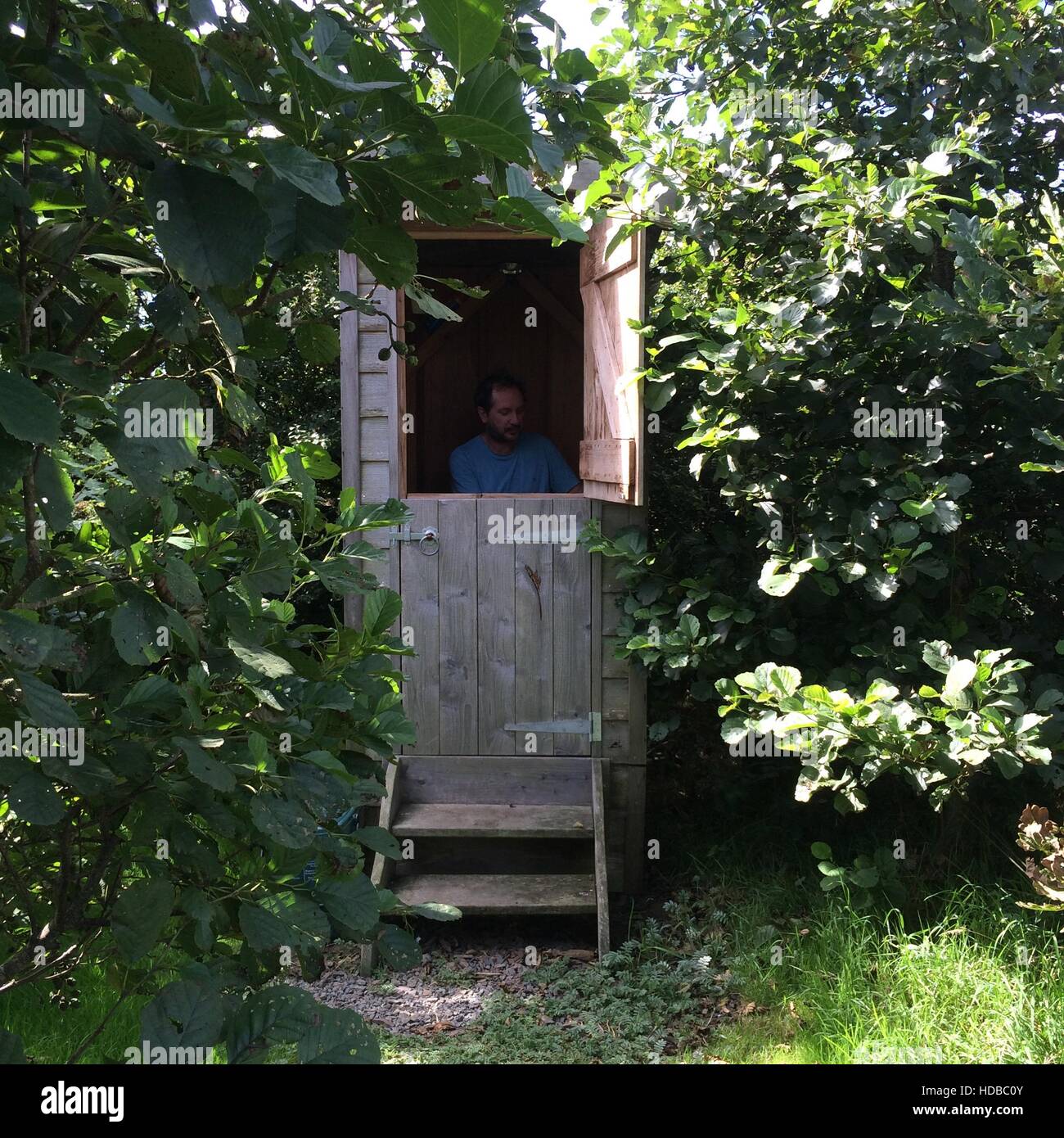 compost composting ecotoilet toilet wooden eco man waterless environmentally friendly Stock Photo