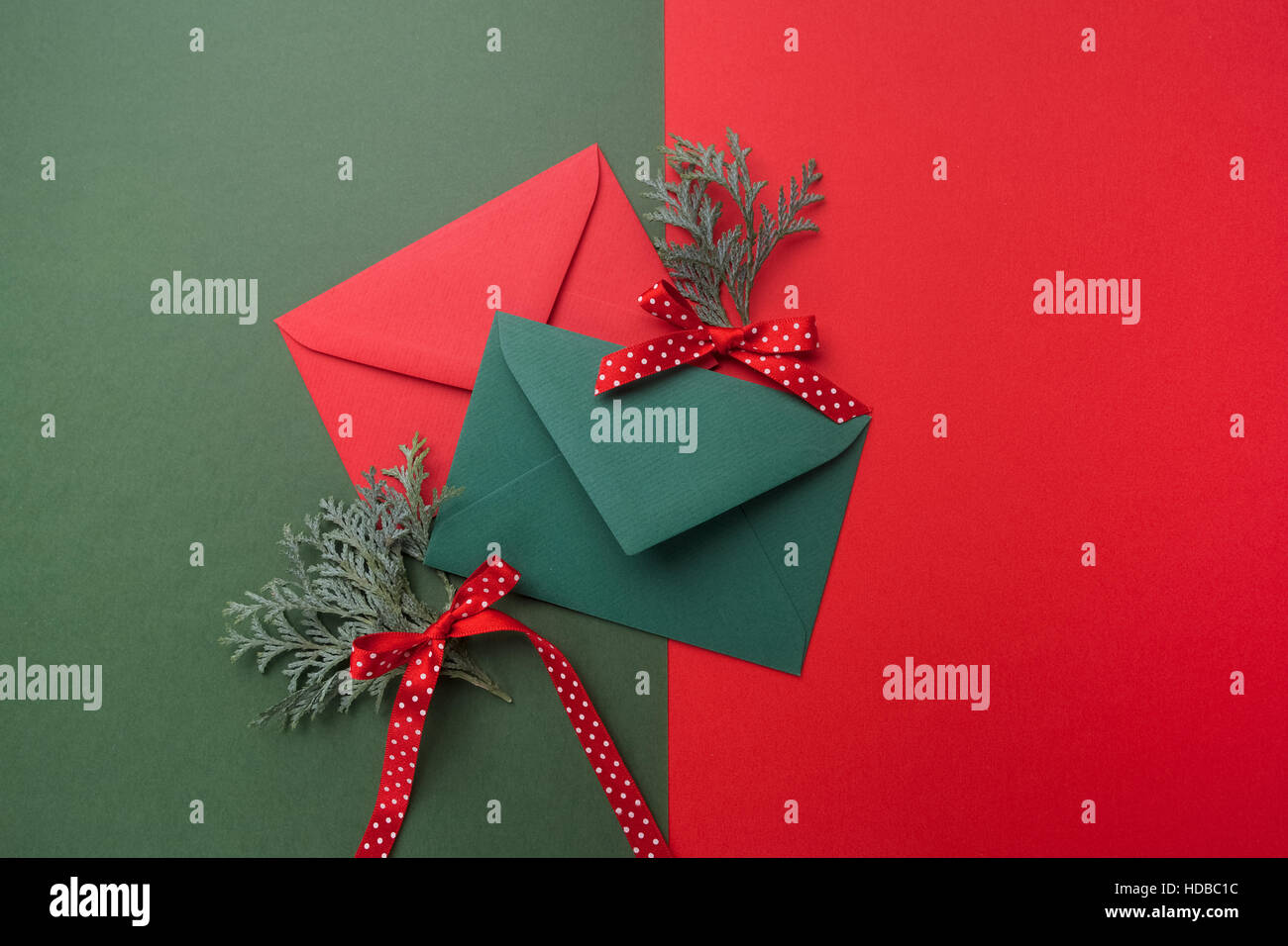 Red and green envelopes on christmas holiday background flat lay stock