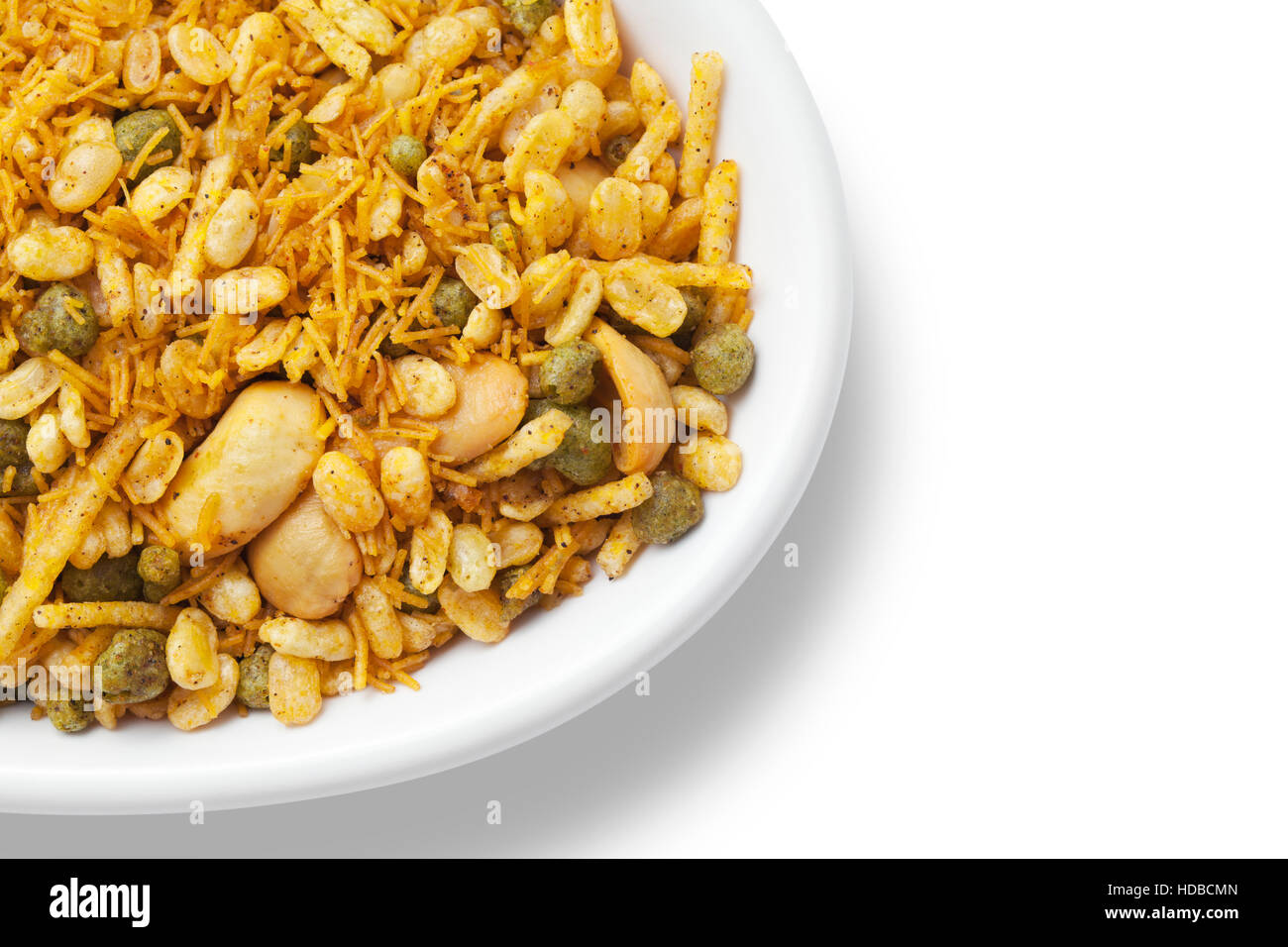 Dry roasted Indian snack mix in a big spoon, isolated Stock Photo