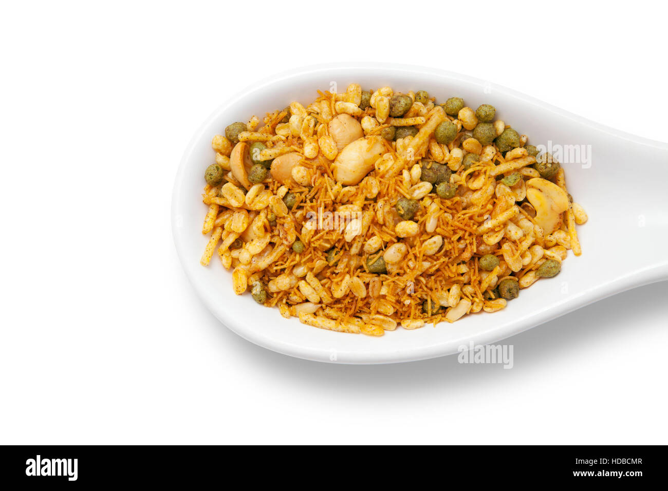 Dry roasted Indian snack mix in a big spoon, isolated Stock Photo