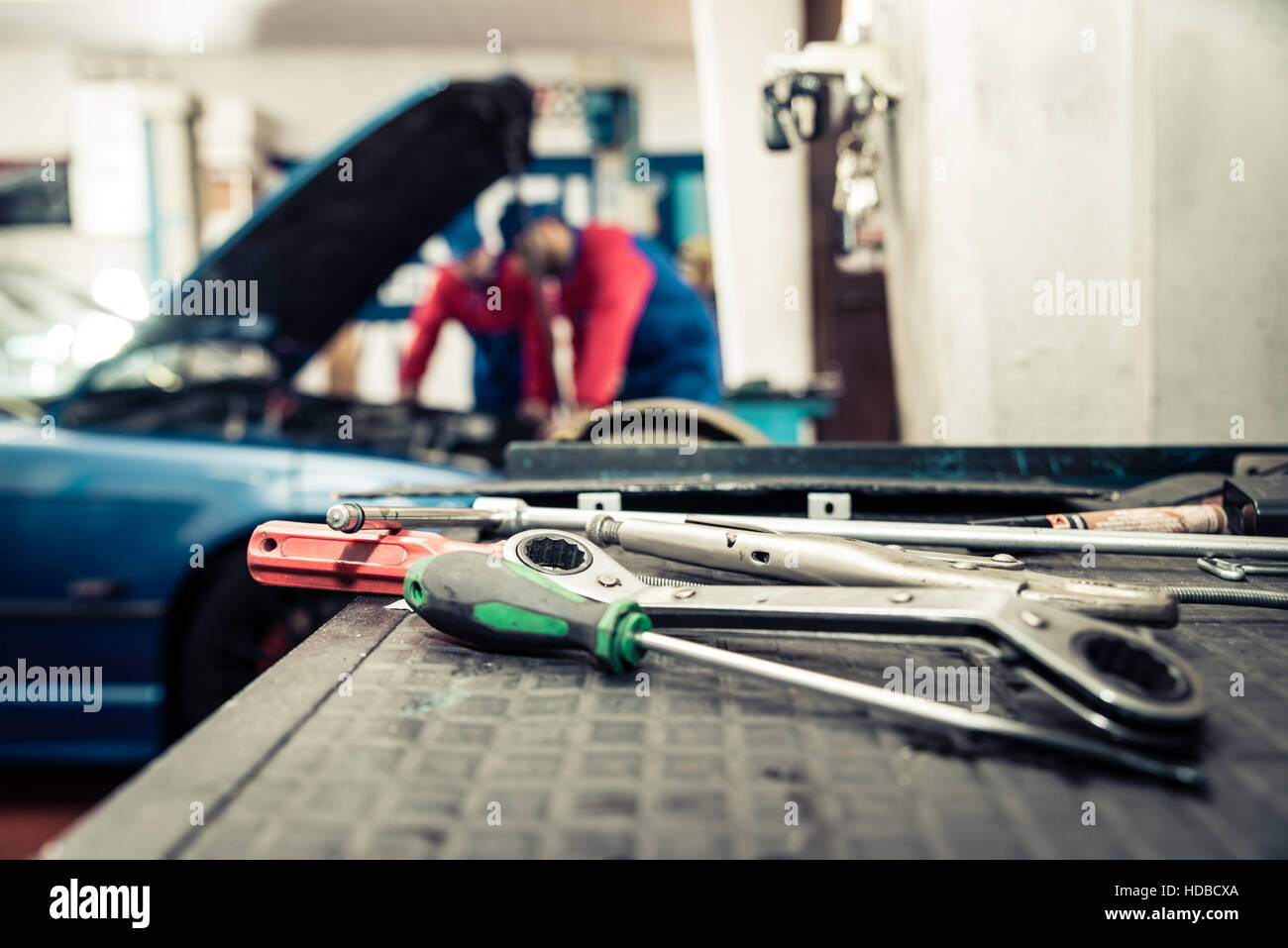 Car mechanics checking the engine Two men working on in a