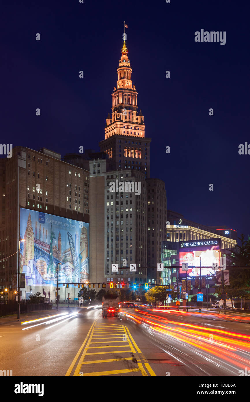 Rush-hour traffic creates light trails heading for the downtown area and the Terminal Tower complex prior to sunrise in Cleveland, Ohio. Stock Photo
