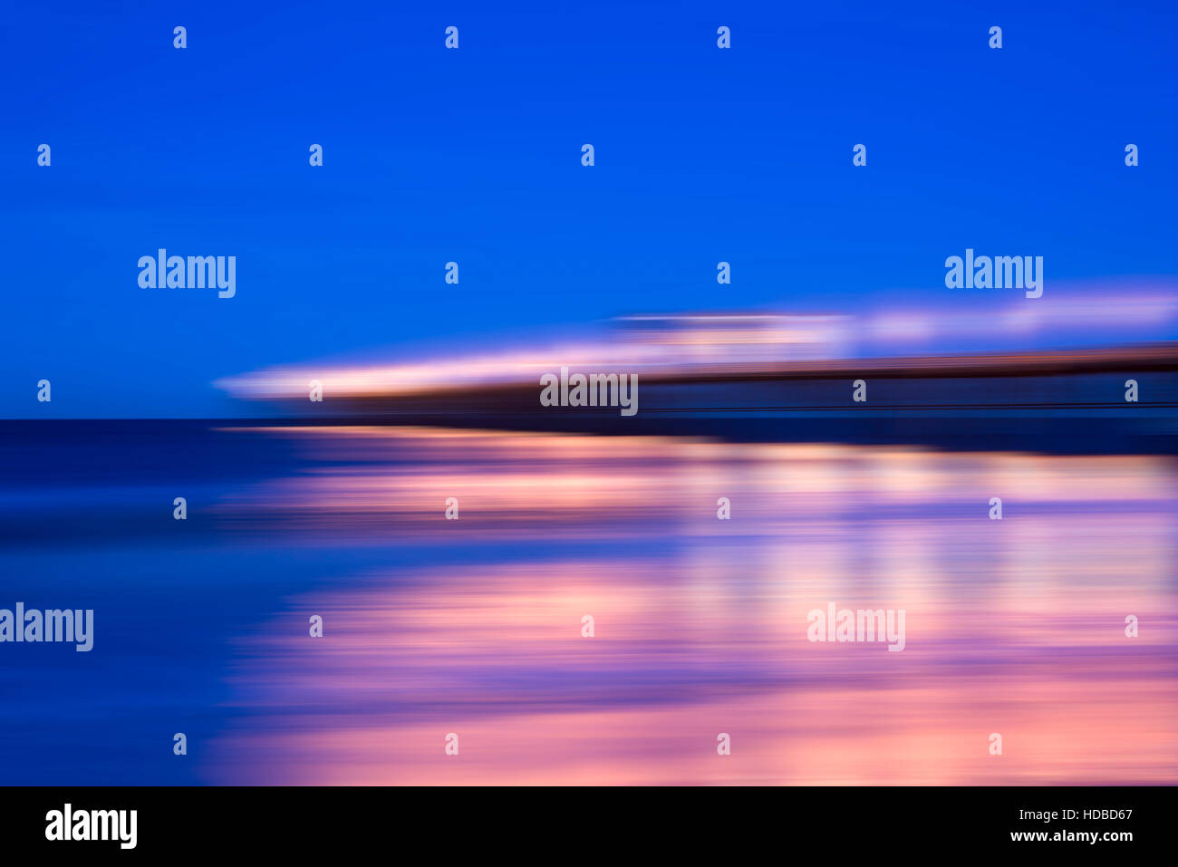 motion blur effect, pier with lamppost at night. Stock Photo