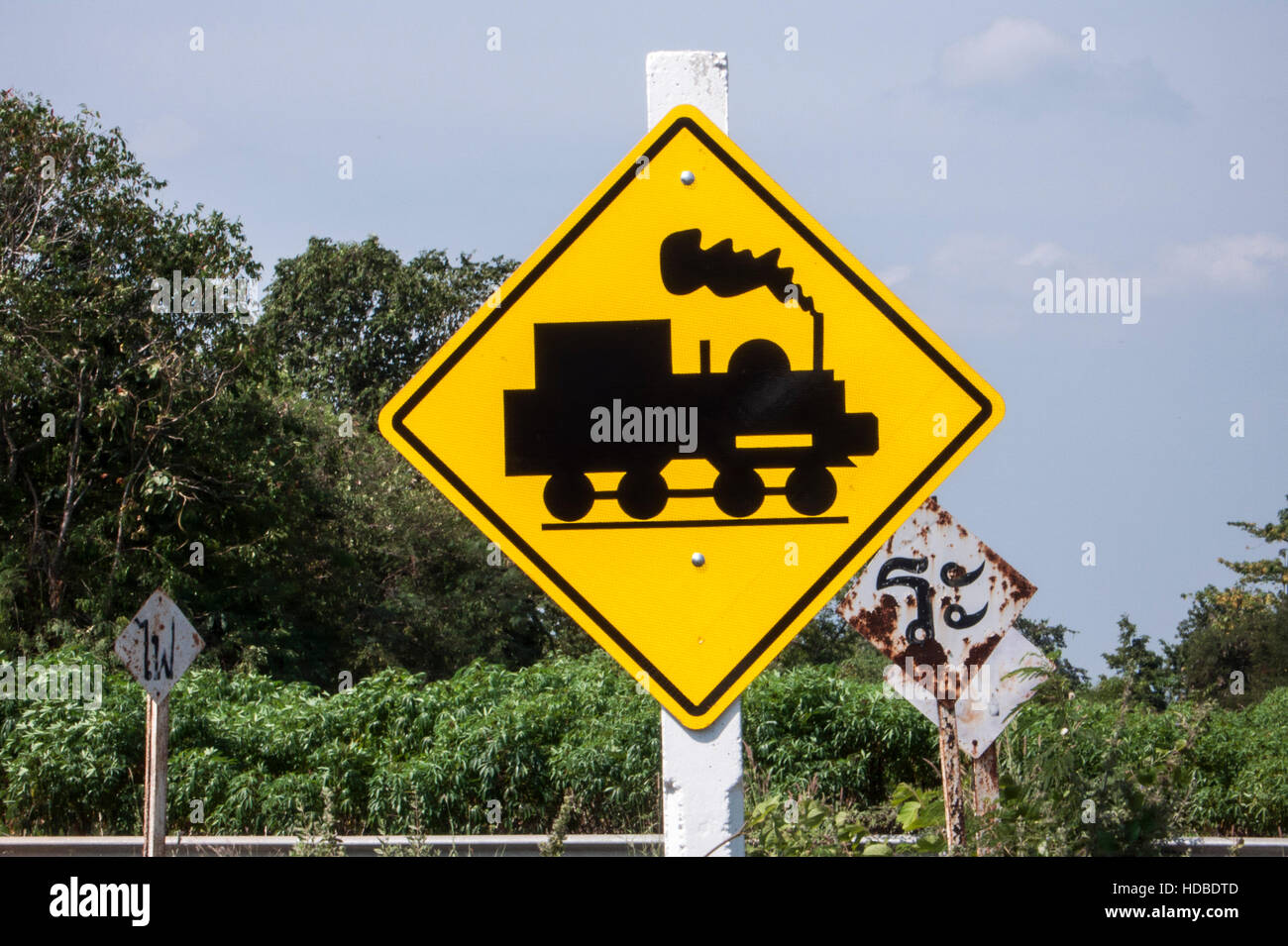 Road sign warning of Burma Railway train near Kanchanaburi Thailand Stock Photo