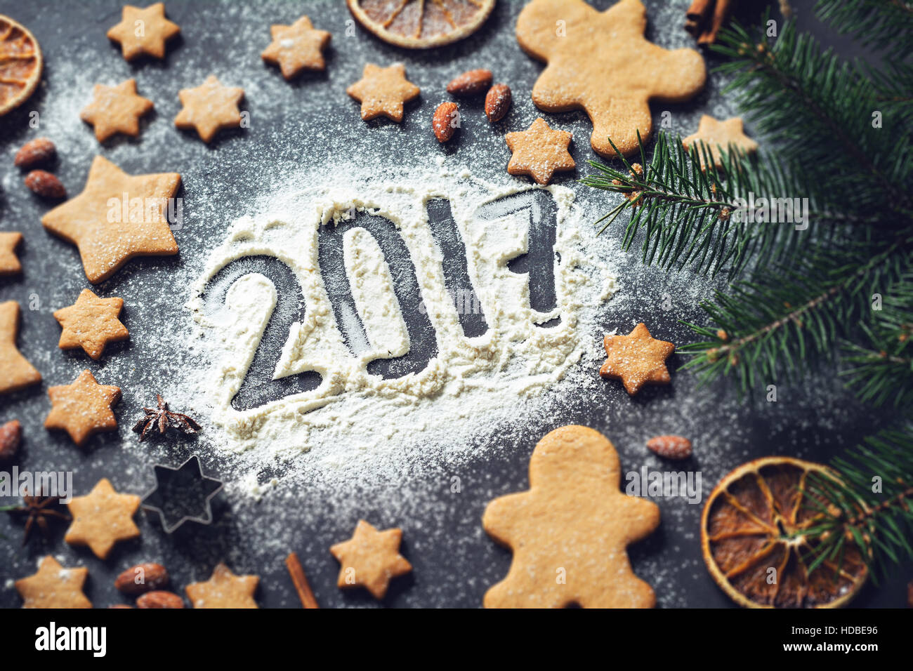 Happy New Year 2017 card: frame of gingerbread cookies, stars, fir tree, spices and Christmas decorations with number 2017 Stock Photo
