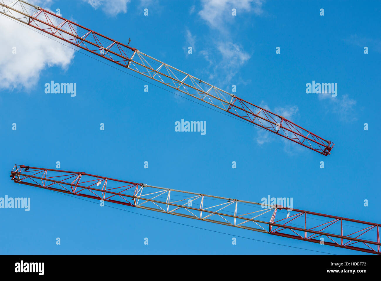 Two building crane in front of blue sky Stock Photo - Alamy