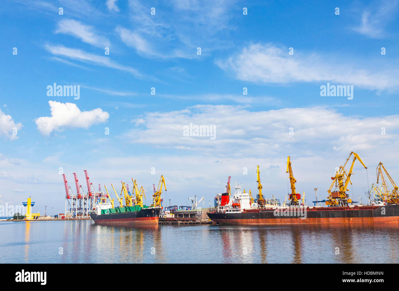 Lifting cargo cranes, ship and grain dryer in Sea Port of Odessa, Black Sea, Ukraine Stock Photo