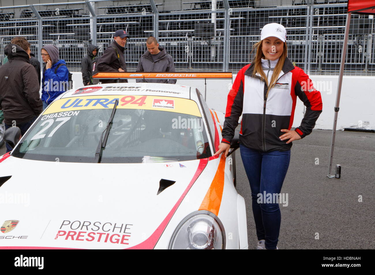 Quebec business woman and race car driver, Valerie Chiasson poses beside her Porsche which she will race in the Porsche GT# Cup Challaenge at Circuit Stock Photo