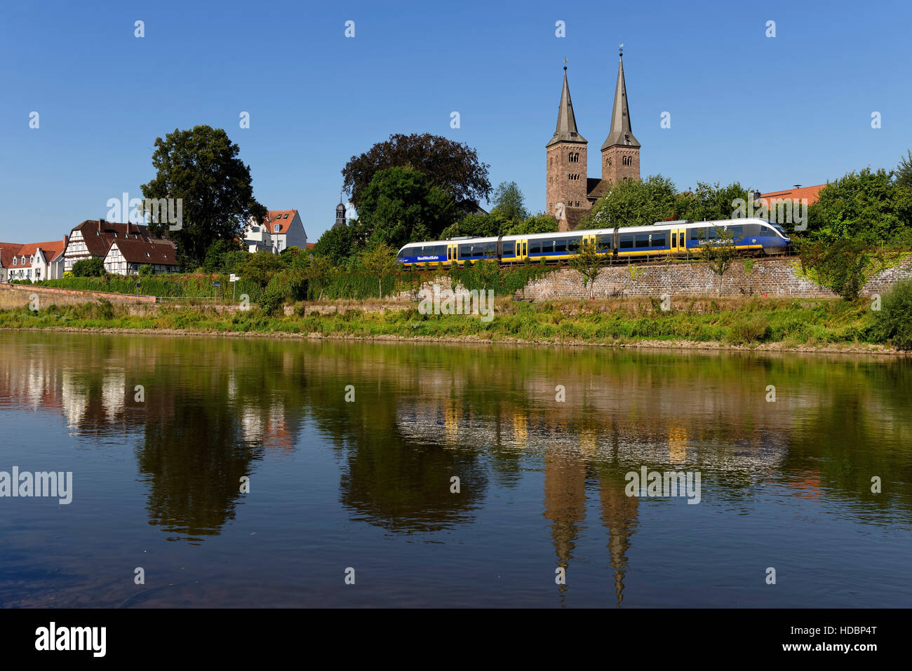 View of Höxter with train at river Weser and church of Saint Kilian, North Rhine-Westphalia, Germany Stock Photo