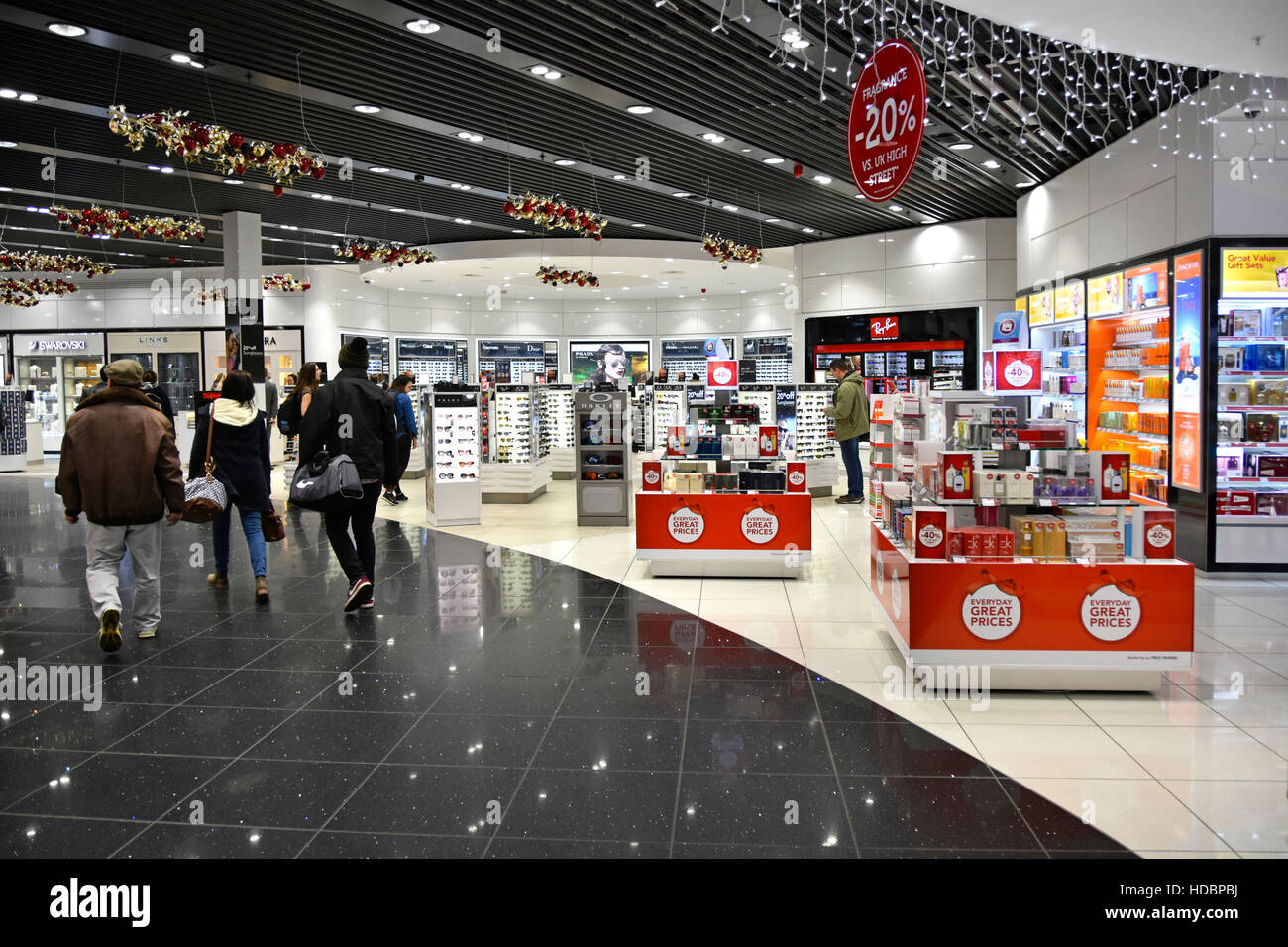 Airport terminal airplane passengers at Stansted Airport London  walking through retail shopping mall on way to departure lounge Essex England UK Stock Photo