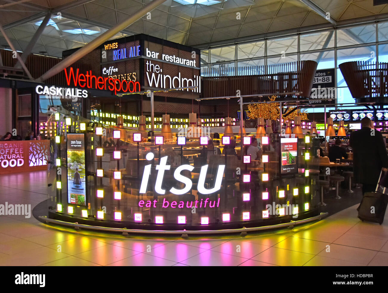 Fast food restaurant from Itsu & other refreshment facilities in departure lounge in airport terminal building at Stansted Airport London England UK Stock Photo