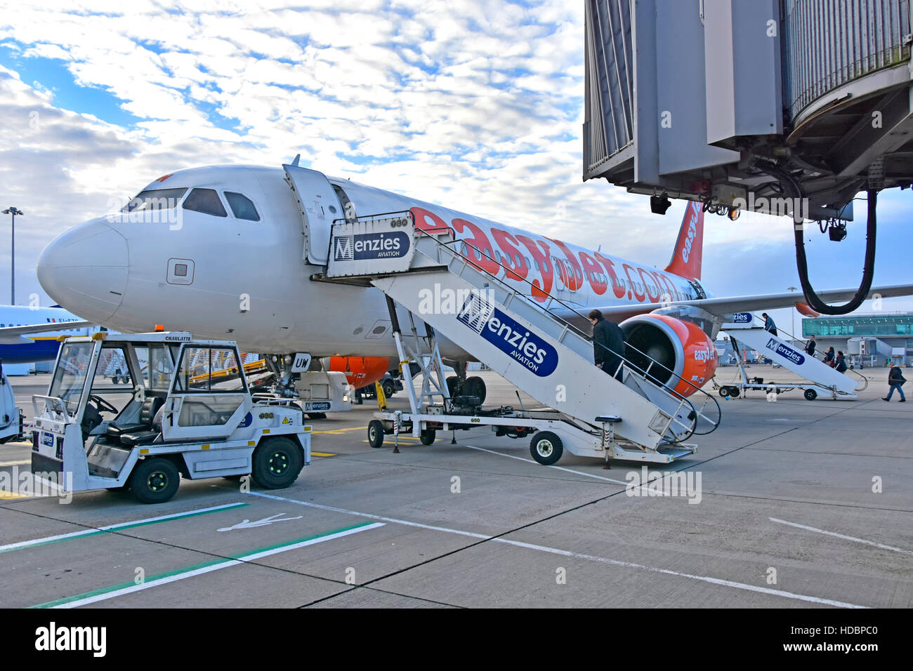 Stansted Airport London, passengers Menzies Aviation boarding steps walk EasyJet airplane unused jet bridge plane corridor overhead, aeroplane beyond Stock Photo