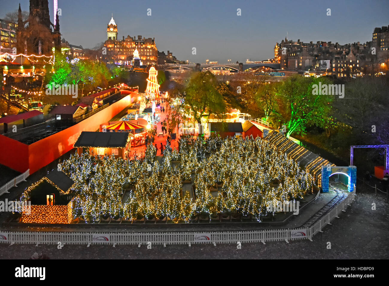 Scottish Edinburgh European Christmas Market and fairground scene in East Princes Street gardens beside the Scott Monument town centre Scotland uk Stock Photo