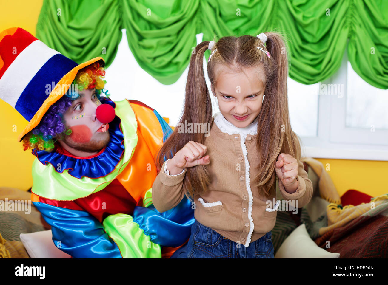 Child girl and clown playing on birthday party Stock Photo Alamy