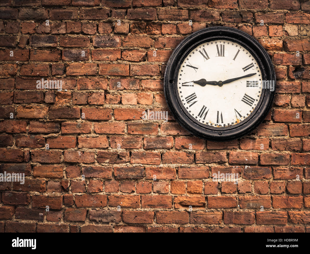 Vintage Station Clock On A Red Brick Wall Stock Photo