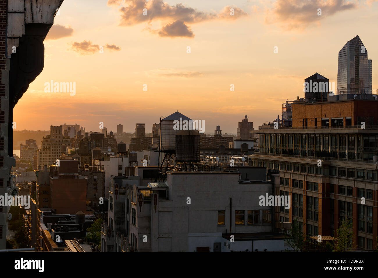 Chelsea rooftops in summer sunset light with highrises and water