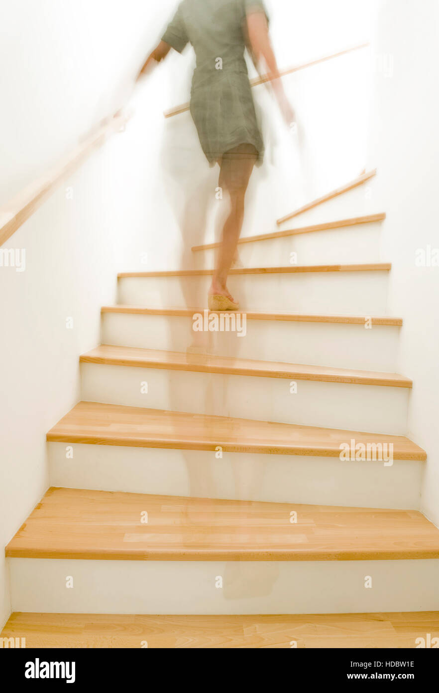 Woman climbing stairs Stock Photo Alamy