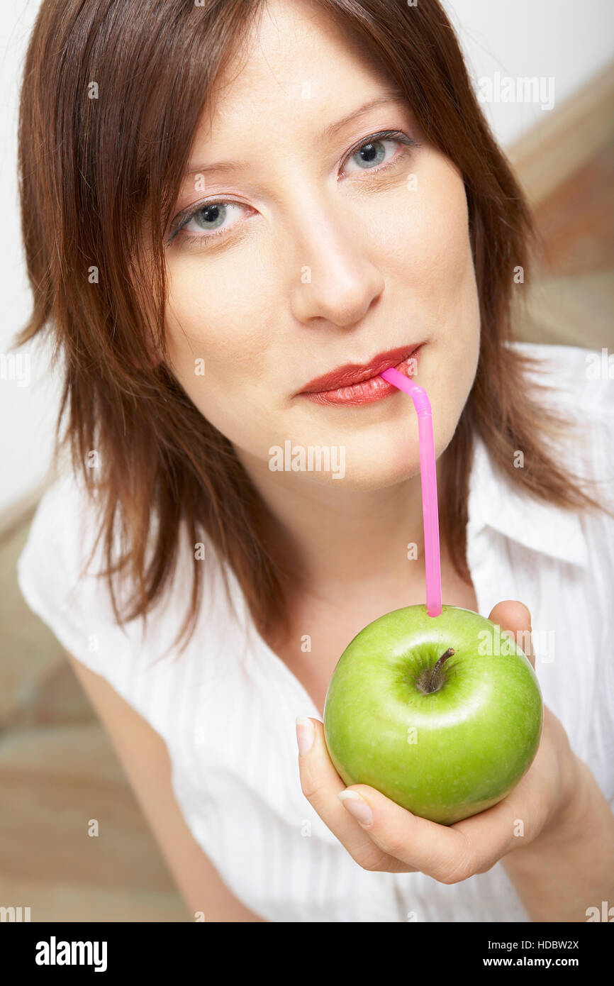 Woman drinking pure apple juice Stock Photo