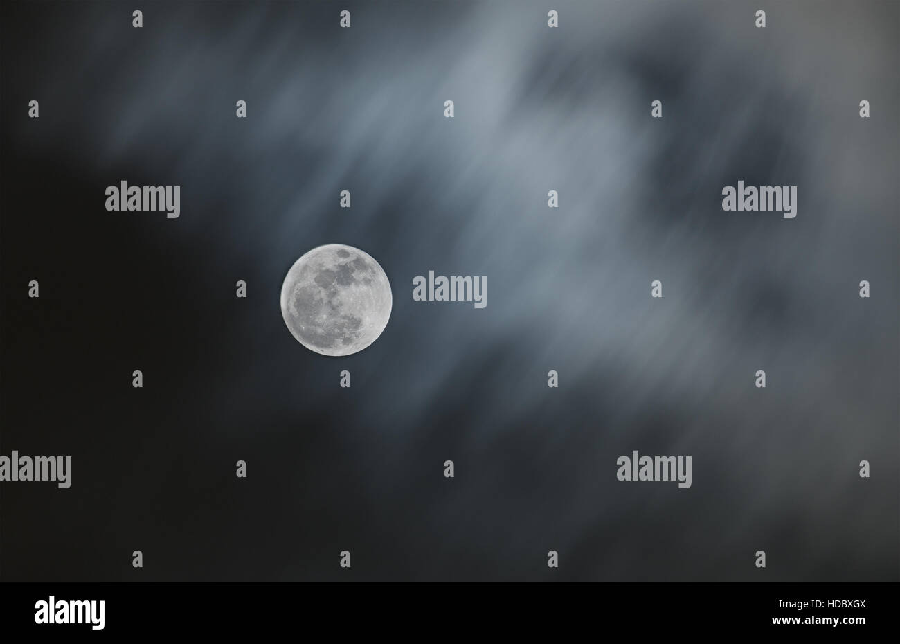 Bright full moon with blurry moving cloud of night sky. Elements of