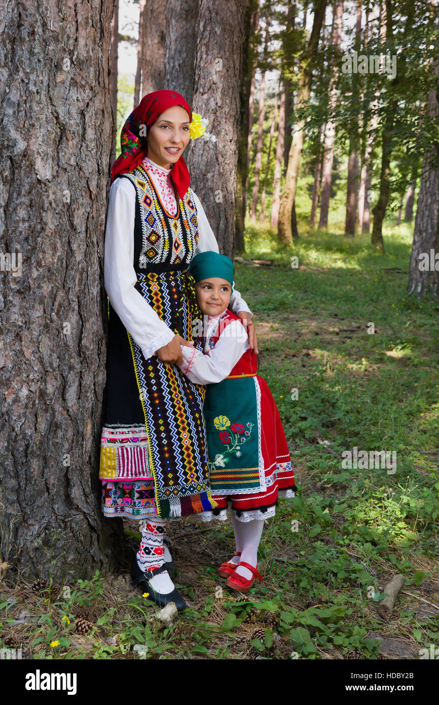 Young mother posing with her little girl in traditional Bulgarian costume Stock Photo