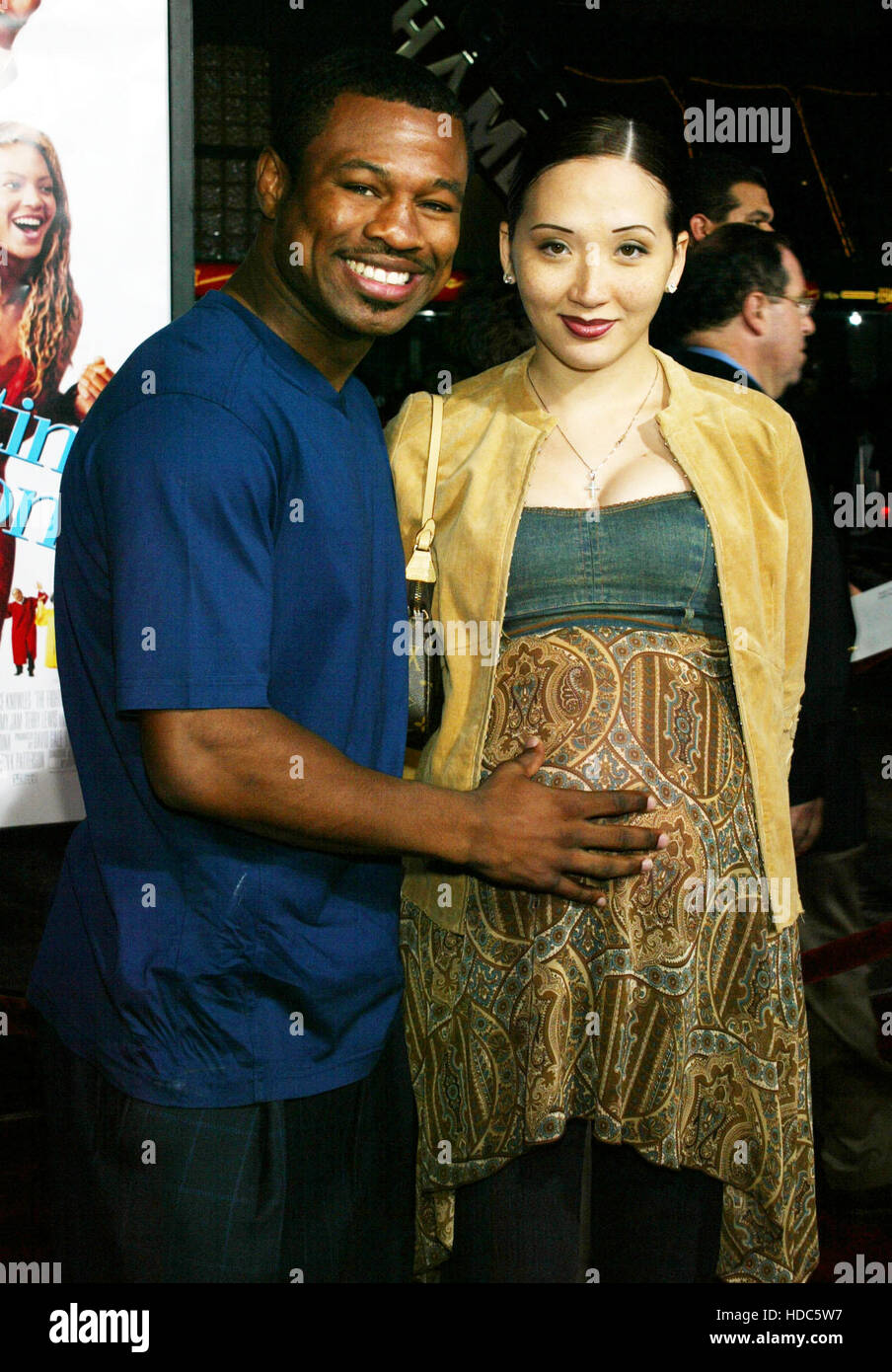 FBS12 20030917 HOLLYWOOD, UNITED STATES :  Boxer Shane Mosely, left, with his pregnant wife, Jin, pose during the movie premiere 'The Fighting Temptations' in Hollywood,  on  Thursday, 17, September 2003. The film was produced by Paramount Pictures and stars Beyonce Knowles and Cuba Gooding, Jr. Photo by Francis Specker Stock Photo