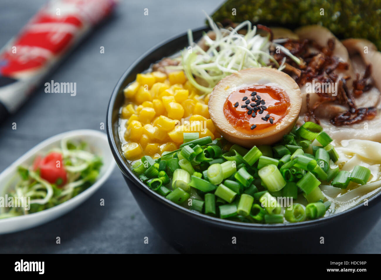 tonkotsu ramen, japanese noodle soup with pork belly, corn, spring